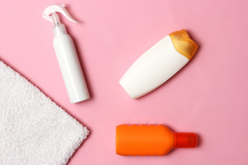 sunscreen, towel, hat, glasses on a colored background. Cosmetics for prevention of sunburn. top view, flatlay 