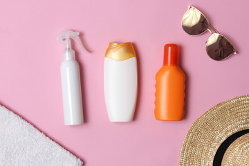 sunscreen, towel, hat, glasses on a colored background. Cosmetics for prevention of sunburn. top view, flatlay 