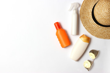 sunscreen, towel, hat, glasses on a white background. Cosmetics for safe sunburn. top view, flatlay