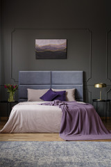 Spacious bedroom interior with painting