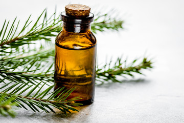Obraz na płótnie Canvas Spruce needle aromatherapy essential oils in bottles on white ta