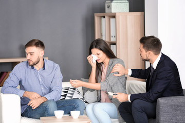 Psychologist working with married couple in office