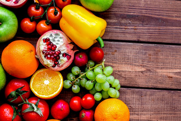 cooking salad with fresh fruits and vegetables on wooden backgro