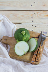 Green zucchini balls. Wooden table and board. 