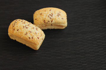 fresh mini bread on black wooden table