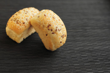 fresh mini bread on black wooden table