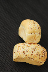 fresh mini bread on black wooden table
