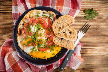 Homemade breakfast fried egg with tomato.