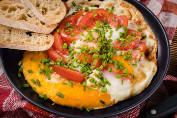 Homemade breakfast fried egg with tomato.