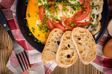 Homemade breakfast fried egg with tomato.