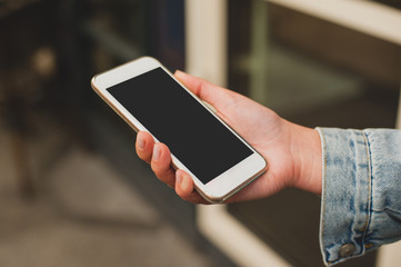 Mock up women's hands holding white smartphone. Place for text, your design, presentation website or app.