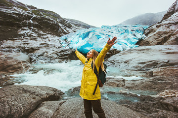 Happy Woman tourist traveling sightseeing Nigardsbreen glacier in Norway healthy Lifestyle...