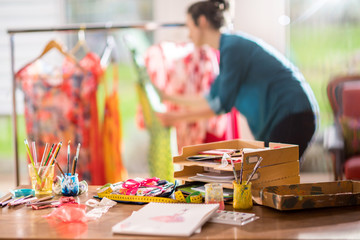 Fashion designer working on a new model, in her studio