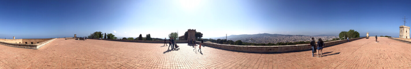 BARCELONA - MAY 11, 2018: Tourists enjoy city view from Montjuic Castle terrace. Barcelona attracts 10 million tourists annually