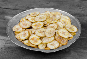 Banana Chips Popular Deep Fried Tea Time Snack on Dark Wooden Background