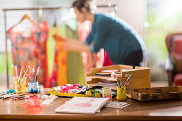 Fashion designer working on a new model, in her studio