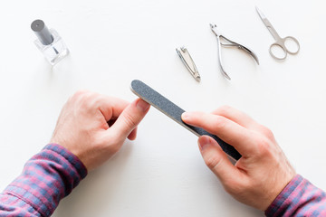 man doing a manicure on a white background