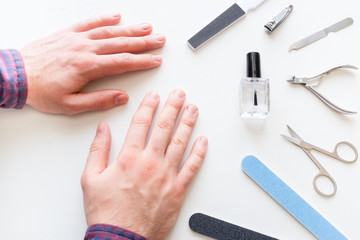 man with not well-groomed nails in the salon of manicure