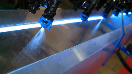 The nozzle of the watering machine sprays water.