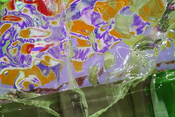 An image of an ice wall with frozen multicolored lamps.