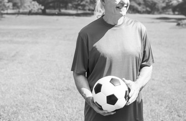 Mature man holding a football