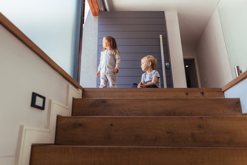 Kids on stairway looking outside