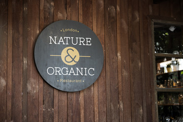 Black sign on a wooden wall mockup