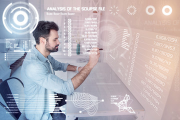 Drawing carefully. Attentive calm experienced designer holding a modern stylus while sitting alone...