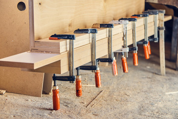 Clamps tightening plywood