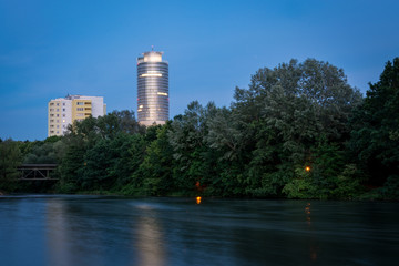 Lit Business tower at the lake Woehrder See in Nuremberg during blue hour