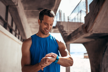 Athlete checking his progress on smartwatch fitness app