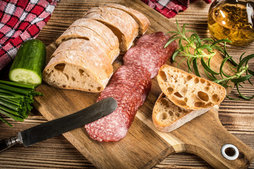 Italian ciabatta bread cut in slices with salami.