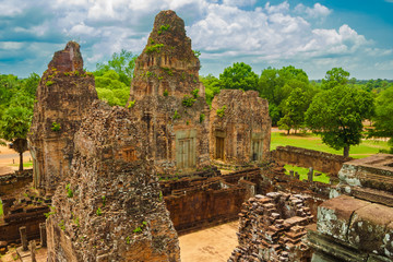 The summit of Pre Rup's central sanctuary gives a great view of its reddish tower ruins on the east side of the Hindu temple in Angkor, Siem Reap, Cambodia.