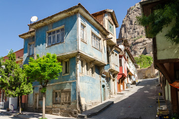 Beautiful old street in downtown with houses with wooden shutters in the classic Turkish Ottoman style, Turkey, center of Afyonkarahisar The two-storyed buildings
