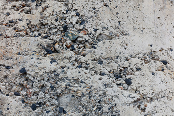 texture of gray concrete close-up. interspersed with colored elements