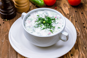 Okroshka on kefir on wooden table