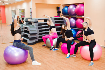 Fototapeta na wymiar Women working out with exercise ball in gym.