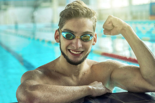 Swimmer man. Portrait of swimming athlete with goggles after tra