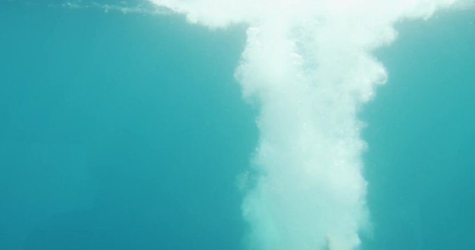 Underwater Footage of Man Jumping into Water and Swimming. Diving in the Ocean. Shot on RED Epic 4K UHD Camera.