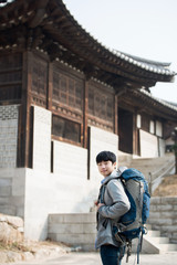 Fototapeta na wymiar young man doing a backpacking trip in a Korean traditional house. Selective focus