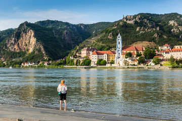 Woman looking at the Durnstein along the Danube River. Austria.