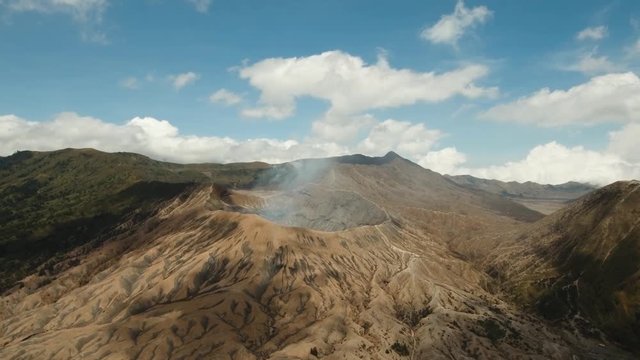 Crater with active volcano smoke in East Jawa, Indonesia. Aerial view of volcano crater Mount Gunung Bromo is an active volcano,Tengger Semeru National Park. 4K video. Aerial footage.