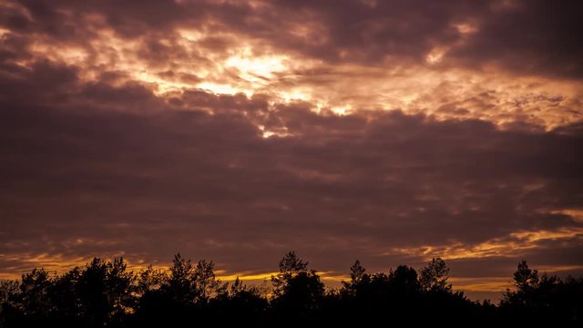 Quickly floating dark clouds in cloudy twilight and sunset