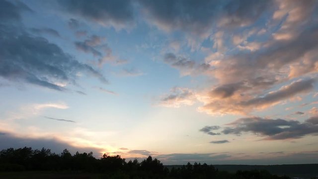 Quickly floating dark clouds in cloudy twilight and sunset