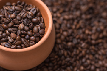 Clay pot filled with coffe beans. Horizontal view