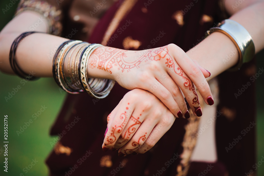 Wall mural mehndi tattoo. woman hands with black henna tattoos. india national traditions - Wall murals