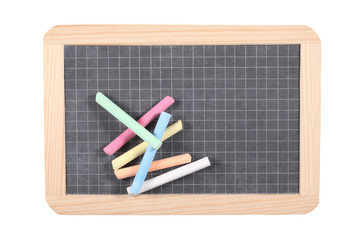 school concept: close up on a slate blackboard with chalks and copy space.