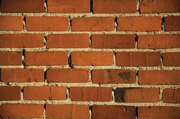 Fototapeta premium Orange brick pattern on house wall in Tielt. Charming and quiet village in the countryside, near Ghent and surrounded by agricultural fields. Western Belgium.