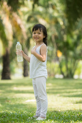 Child drinking pure water in nature