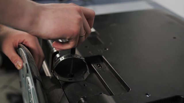Technician repairing a television. Hand with voltmeter above board with components. Repair of circuits electric equipment, close up